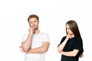 Studio shot of a couple quarreling. Dissatisfied woman looks with suspicion at the partner
