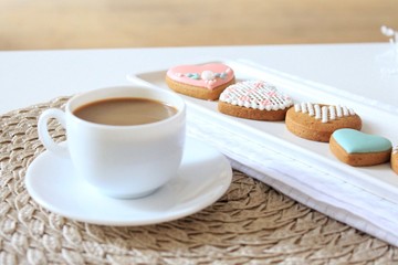 cup of coffee and cookies on wooden table