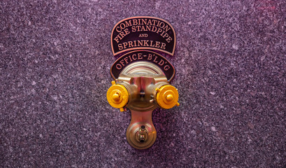 Fire standpipe outdoors on an office building facade, New York, Manhattan