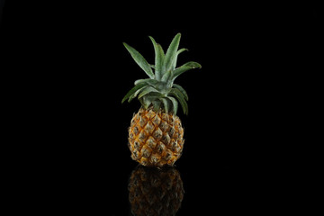 Fresh pineapple isolated on black background