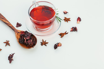 Tea in a glass cup with spices and herbs. Top view.
