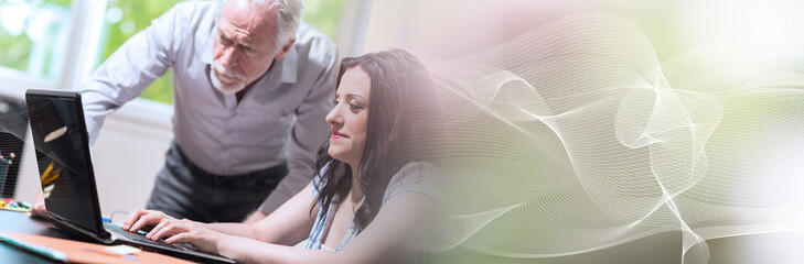 Obraz premium Young businesswoman and senior businessman working together; panoramic banner