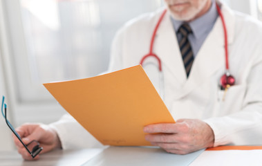 Doctor reading a medical report