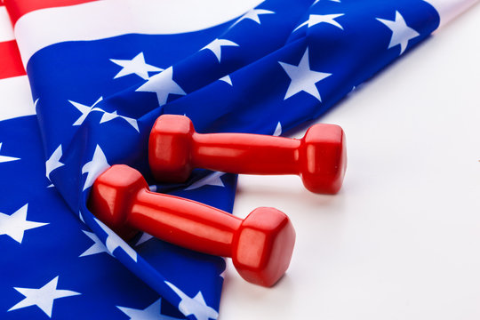 Dumbbells over USA flag. Healthy nation.