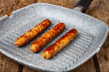 Kupaty in a frying pan