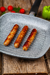 Kupaty in a frying pan