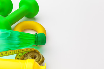 Bottled water for healthy life and measuring tape over a white background