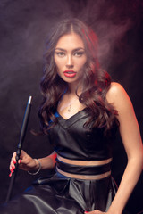 Beautiful woman in smokes hookah or shisha. White cloud vape. Dark background