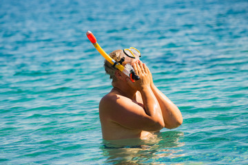 Man with snorkeling tube in sea