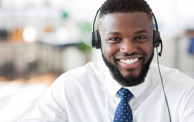 Portrait of cheerful african customer service representative with headset