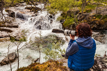 Tourist with camera at river, Norway