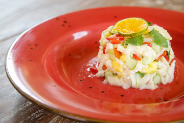 Vegetarian mushroom ceviche served on a red ceramic plate, fine casual dining concept	