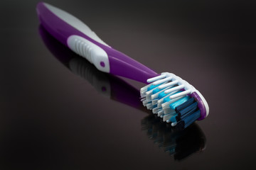 Modern toothbrush on a dark surface close-up