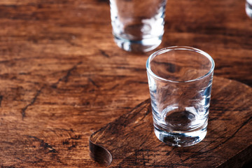 Empty shot glass for vodka, tequila or moonshine, copy space, selective focus