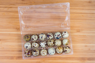 Top view of quail eggs in open plastic packaging