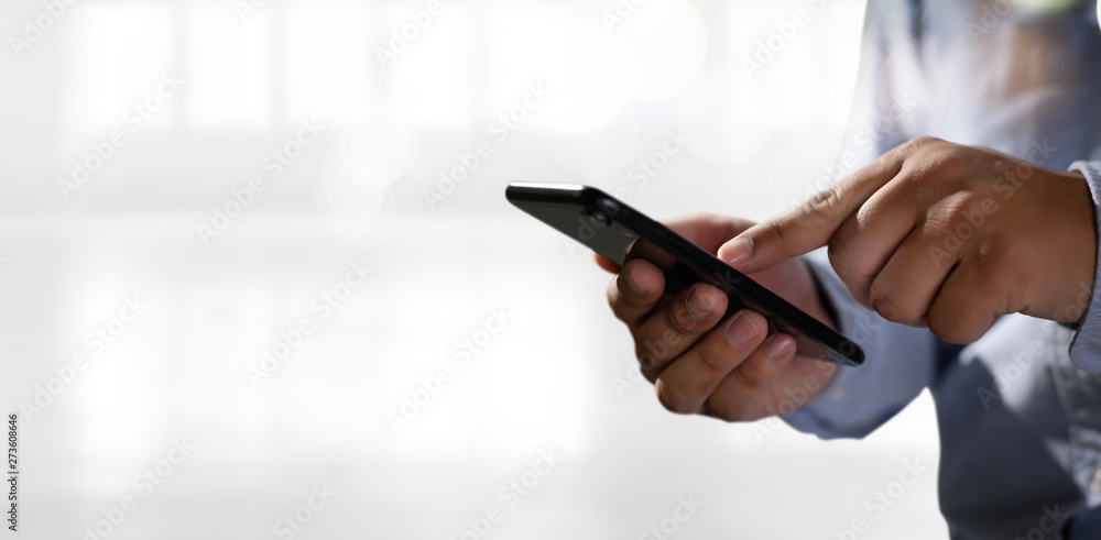 Aufkleber man holding en hands and using digital tablet mobile phone telephone with blank copy space scree