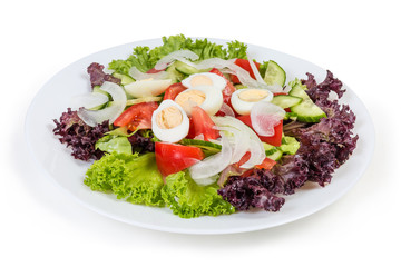 Vegetable salad with boiled quail eggs on the white dish