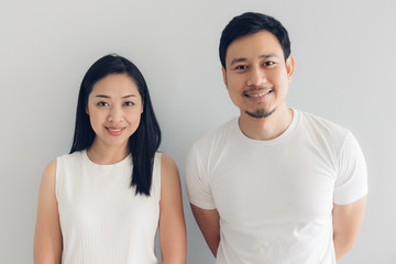 Fototapeta premium Happy couple lover in white t-shirt and grey background.
