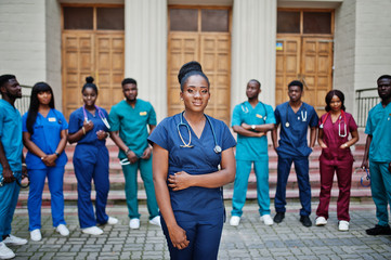 Fototapeta premium Group of african medical students posed outdoor against university door.