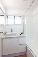 Fototapeta na wymiar Bathroom with a Window, Tub and Basin