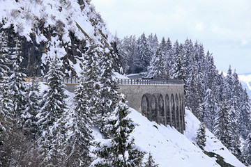 Stony bridge or viaduct on the Rossfeldstrasse in winter