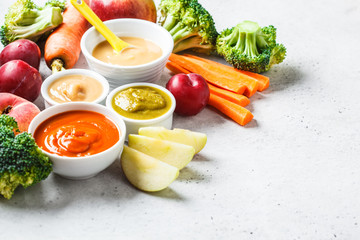 Vegetable and fruit baby puree in white bowls with ingredients. Baby food concept.