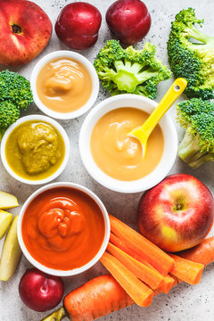 Vegetable and fruit baby puree in white bowls with ingredients. Baby food concept.