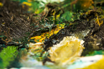 Background image of bright oil-paint palette closeup.