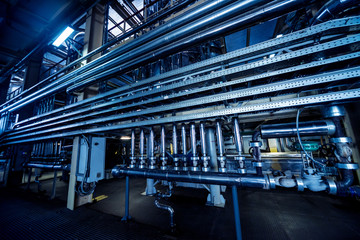 Interior of modern natural oil factory. The piping, pumps and motors
