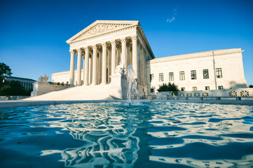 Bright scenic sunny view of the front exterior of the United States Supreme Court building with...