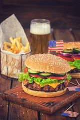 American Burger with bacon,cheese,tomato,lettuce and french fries at a Picnic for fourth of July