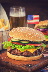 American Burger with bacon,cheese,tomato,lettuce and french fries at a Picnic for fourth of July
