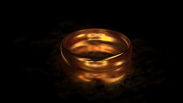 Flying around the gold ring on the matte glass surface with reflection