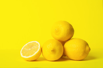 Fresh juicy lemon slides on a bright yellow background. Concept minimalism. Horizontal frame. Copy...