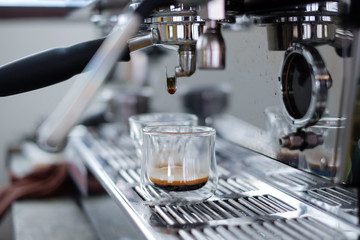Close-up of an espresso machine making a cup of coffee.