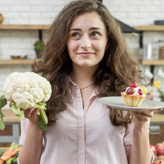 Brunette woman with cabbage and muffin