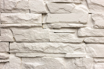 Close-up of white solid limestone wall or stone fence. Abstract copy space background, Bricklaying, construction and masonry concept.