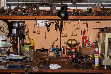 Fototapeta na wymiar Ancient store with mechanic tools, old fashioned fan, balance scale, cutting, wrench, screw are on shelf in a garage. With many old vintage items collections. High quality stock image. 