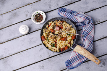 Pasta with mushrooms and sausages