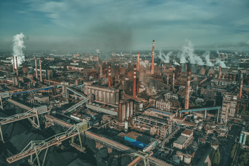 Industrial zone landscape aerial view with smoke from metallurgical factory or plant chimneys. Air and environment pollution, global warming