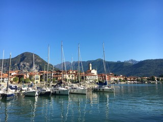 Fototapeta na wymiar Feriolo, Maggiore lake, Italy. View of the small harbor of the village on the lake.
