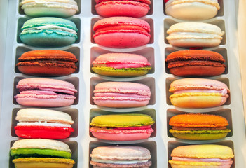 Colorful macaroon cookies in a box, closeup. Almond Dessert Background