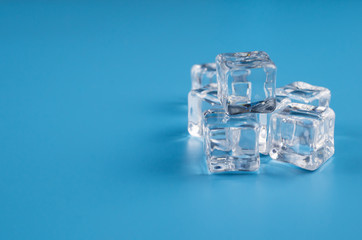 melting ice cubes on blue background