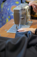 working with a black cloth on a Soviet sewing machine with black threads