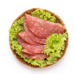 Sandwich with salami sausage on white background.