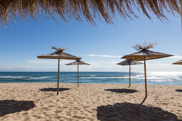 reed beach umbrella against the blue sea
