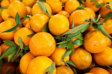 orange fruit stacked on the marketplace