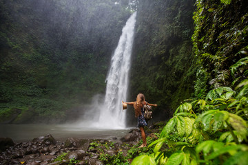 Woman near Nung Nung waterfal on Bali, Indonesia