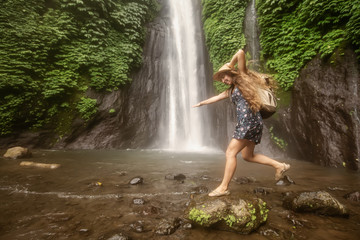 Woman near Munduk waterfal on Bali, Indonesia