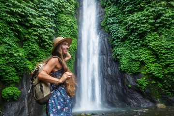 Fototapeta premium Woman near Munduk waterfal on Bali, Indonesia